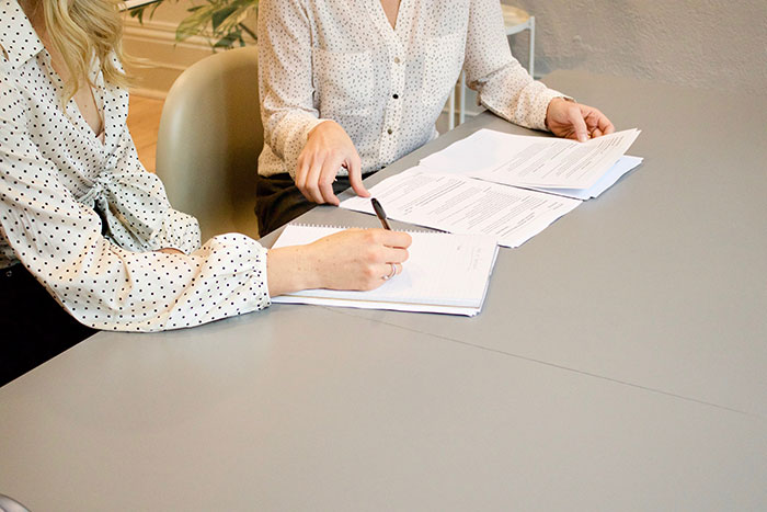 Women Signing Documents